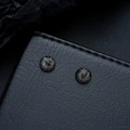 Macro shot of minimalist black basketball stud earrings with precise sphere grid texture - Clip-On Earrings / Gunmetal