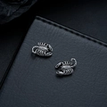 Macro view of scorpion stud earrings with detailed texture on black leather background - Scorpion Ear Clips (X1021-D) / Gunmetal