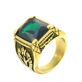 Vintage gold-tone ring featuring a large faceted green gemstone and floral engravings - Size 7 / Gold Base Green Gemstone