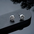 Detail shot of vintage silver scorpion studs with relief carving on a black display stand - Stud Earrings / Silver