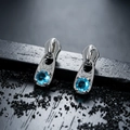 Unique zipper head earrings with blue zircon in silver metal on dark background - Silver