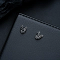 Macro shot of punk wolf head magnetic earrings in gun black finish on leather surface - Gun Black (X1028-D)
