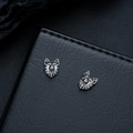 Detailed close-up of a wolf head earring with vintage oxidized finish on black leather - Silver (X1028-C)