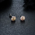 Macro view of champagne gradient round cut earrings with silver four-claw setting - Persimmon Red Fireworks Cut (X8888-L)