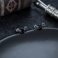 Macro shot of gothic heart earrings with black stone and vintage silver snake relief - Silver (X1081-A)