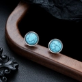 Macro detail of turquoise stud earrings with silver borders on a rustic wood display - Round Turquoise (X1061-C) / 8mm