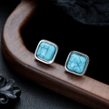 Macro detail of vintage square turquoise earrings with silver bezel setting on dark wood - Square Turquoise (X1061-B) / 10mm