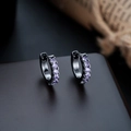 Detailed macro view of S925 sterling silver stamp on black huggie earrings with purple gems - Gun Black Frame + Purple Zirconia (1 Pair)