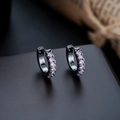 Close-up of black hoop earrings with sparkling pink crystals on a vintage paper backdrop - Gun Black Frame + Pink Zirconia (1 Pair)
