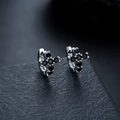 Macro shot of silver cross earrings with black cubic zirconia and secure ring closure - Silver-Black Rhinestone