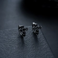 Detailed macro view of black plated cross earrings with sparkling black zircon stones - Gun Black & Black Rhinestone