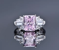 Macro shot of S925 silver ring featuring a pink ice cut stone and side baguette diamonds - US 7 / Pink Zirconia