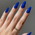 Macro detail showing the glossy finish of cobalt blue almond-shaped press-on nails - Almond Shape / Glossy Blue