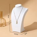 Elegant gold mermaid tail necklace with zircons displayed on a white neck mannequin - 25cm Height / White Leather