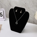 Silver necklace and round earrings set with 'Love' engraving on a black velvet mannequin - Small Apple Style / Black Velvet