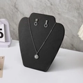Silver jewelry set with daisy necklace and smiley face earrings on black display stand - Small Apple Style / Black Leather