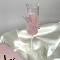 Detail of a flute champagne glass with lavender butterfly accents on white silk - Tall Plain / Purple