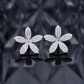 Elegant silver flower stud earrings featuring micro-pave cubic zirconia on dark background - 925 Silver / Silver