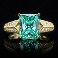 Radiant emerald green ice cut ring in 14k gold plated silver with white side stones - Emerald Green