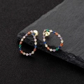Teardrop S925 silver hoop earrings with vibrant multi-color zircons on dark rock - Gold