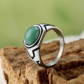 Macro view of vintage titanium steel men's ring with green agate gemstone and carvings - Light Green