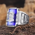 Macro shot of 1973 Walton Tigers ring featuring a blue stone and lion head relief - US 7 / Steel Blue