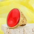 Macro detail of retro gold ring featuring a large oval red gemstone and embossed patterns - Gold Bright Red