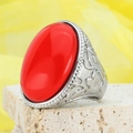 Vintage silver ring featuring a large oval red gemstone with ornate floral relief - US 7 / Steel Red