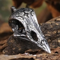 Macro shot of raven skull pendant with vintage engravings on a rustic wood background - Pendant Only (Without Chain) - Steel Color