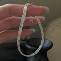 Handheld view of a multi-strand braided S925 sterling silver bracelet with Italy hallmark - Multistrand Braided Style (SLS192) / 925 Silver