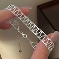 Handheld view of a woven S925 sterling silver mesh bracelet with adjustable beaded chain - 925 Silver / Silver