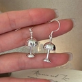 Polished S925 sterling silver lamp-shaped hook earrings shown held by hand with display card - Mushroom Shape (EHM093)