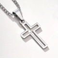 Close-up of a hollow double-frame stainless steel cross pendant on a box chain - Steel