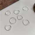 Set of seven minimalist S925 sterling silver wavy rings with a high-polished metallic finish - US 7