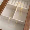Macro detail of gold S925 sterling silver clavicle chain with heart links on white fabric - 925 Silver / 18K Gold