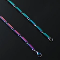 Macro shot of rainbow-colored geometric tube links and lobster clasp on steel chain - Colorful