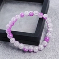 8mm purple and white crackle quartz crystal beaded bracelet on a black display stand - Purple