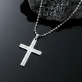 Polished silver stainless steel cross pendant necklace on a sleek black reflective surface - Steel