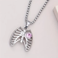 Macro shot of silver skeleton rib cage pendant with a pink heart zircon on square chain - Pink Heart Pendant / Pink