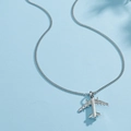 Macro detail of silver airplane pendant necklace showing high-quality metallic finish - Steel