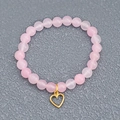 Minimalist pink beaded elastic bracelet featuring a polished gold hollow heart pendant - Hollow Heart Pendant (BCB0006) / Pink