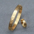 Macro detail of gold stainless steel bracelet and ring with Roman numeral engravings - Gold Bangle & Ring Set (Roman Numerals)