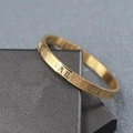 Close-up of golden stainless steel bracelet with engraved Roman numeral scale detail - Gold (Roman Numerals)