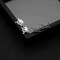 Gothic skull stud earrings in silver and matte black stainless steel for a punk look - Skull and Crossbones Design (Style 1)
