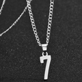 Polished silver stainless steel number 7 pendant necklace on black textured background - Silver Number Seven Style / Silver Number 7
