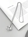 Detailed view of silver geometric layered triangle and square pendant on a magazine - Mixed Geometric Style / Silver