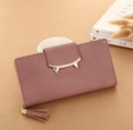 Detail of mauve PU leather wallet featuring golden cat-ear clasp and tassel pendant - Bean Paste Red