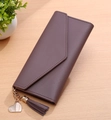 Mauve leather envelope wallet with gold heart charm and tassel on wooden surface - Dust Rose