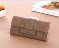 Detail of dark brown long wallet with litchi texture and elegant overlapping buckle - Brown