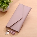 Elegant long envelope wallet in soft pink leather with heart charm and tassel detail - Pink